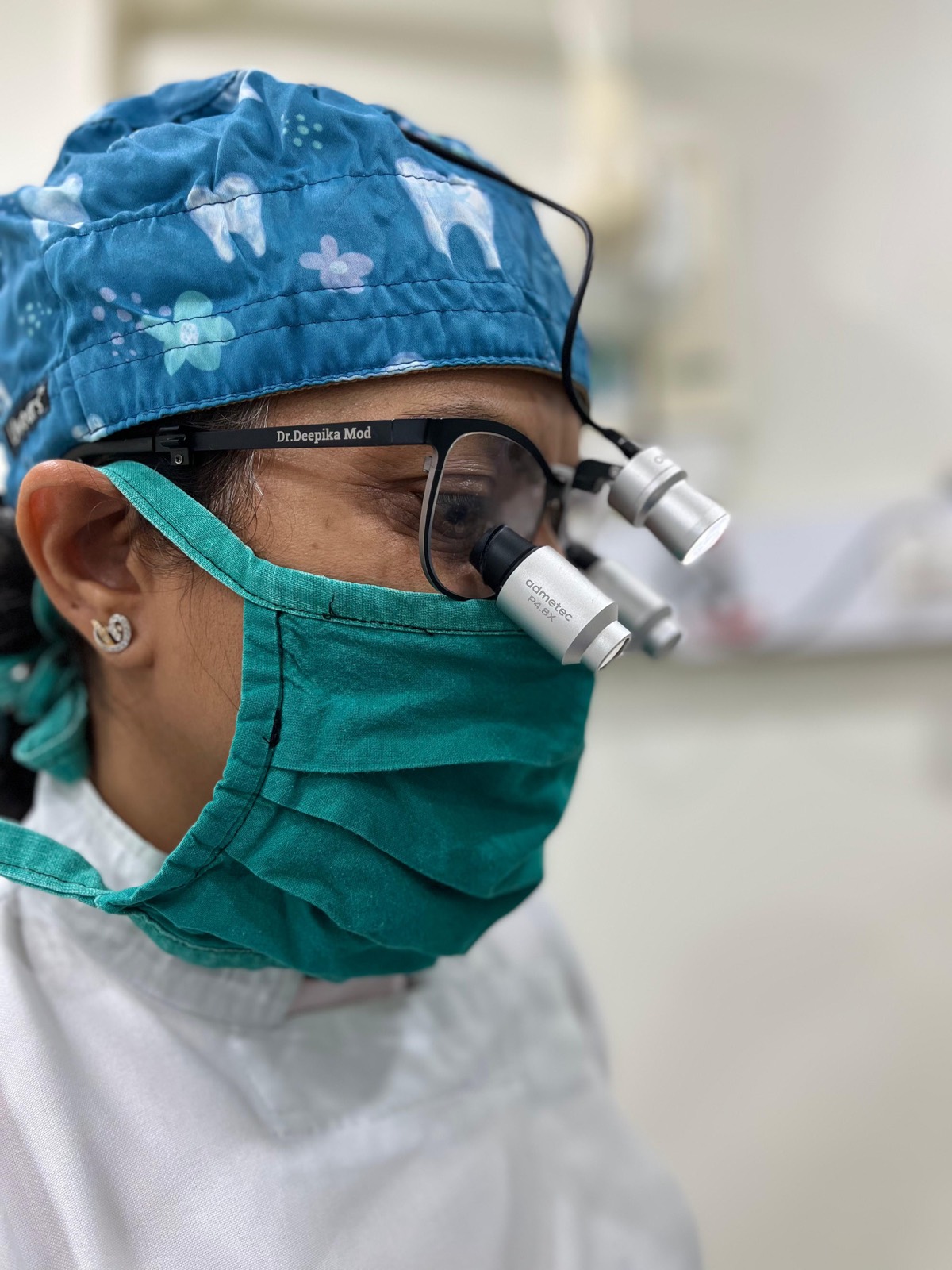 Dr. Deepika Mod wearing surgical loupes at Ritvikk's Tooth Clinic